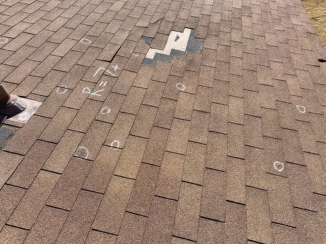 Marked Shingles and an Exposed Roof Section Illustrating Roof Hail Damage Evaluation for Oklahoma City and Yukon, OK